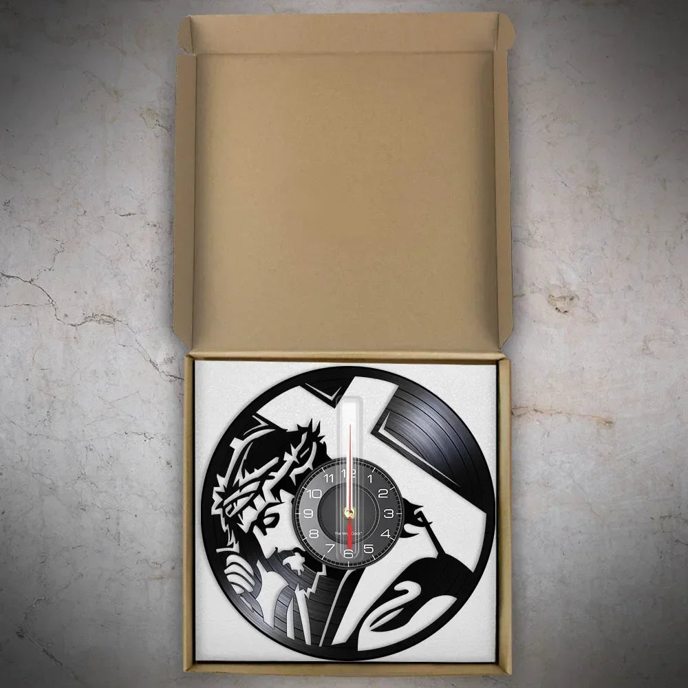 black wall clock featuring a silhouette of Jesus wearing a crown of thorns and a cross in the background made from recycled records